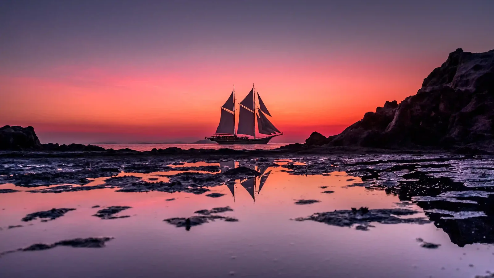 Phinisi sailing boat at sunset near Komodo